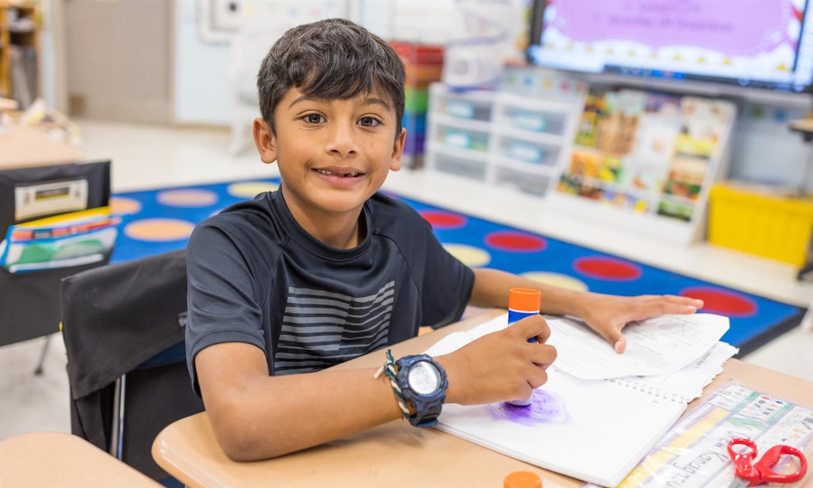 A student smiles